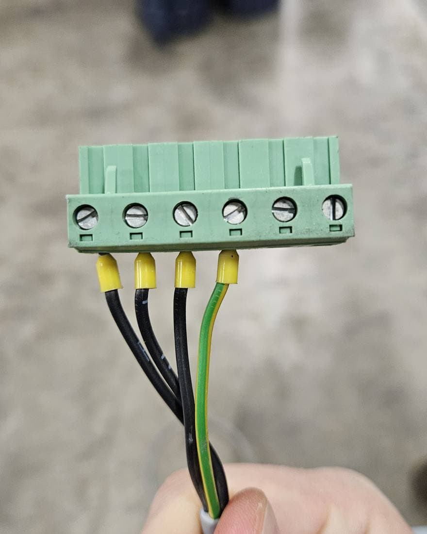 Green pluggable terminal block with ferrule-terminated wires, identified during inspection